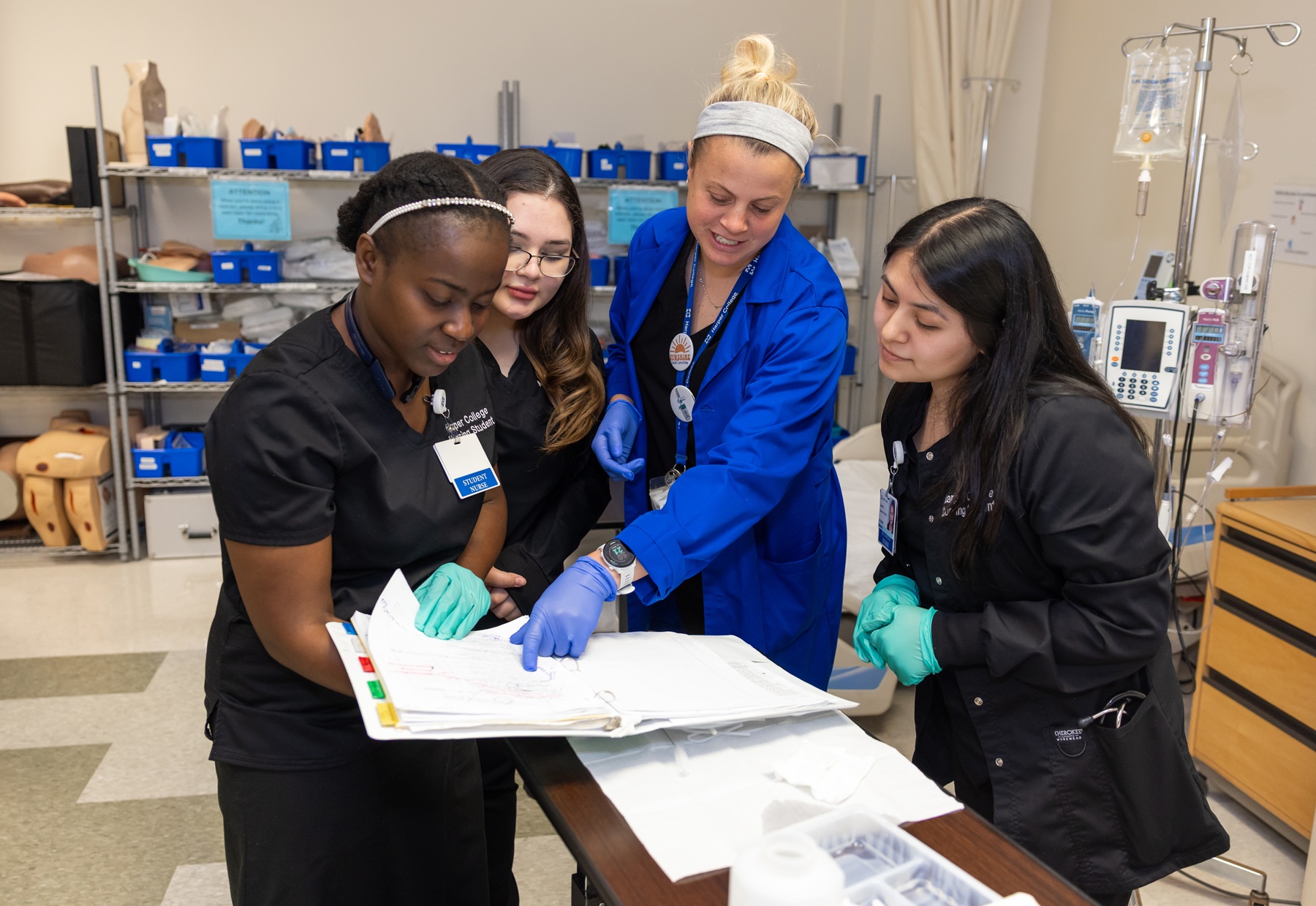 A group of nursing students gathers around a patients' chart