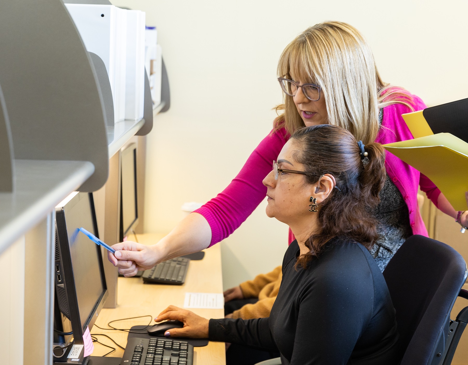 Monika Gadek-Stephan helps a student at the Education and Work Center.