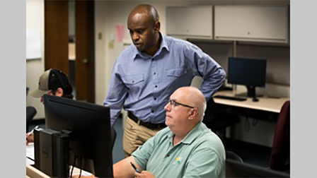 Mukila Maitha works with a GIS student
