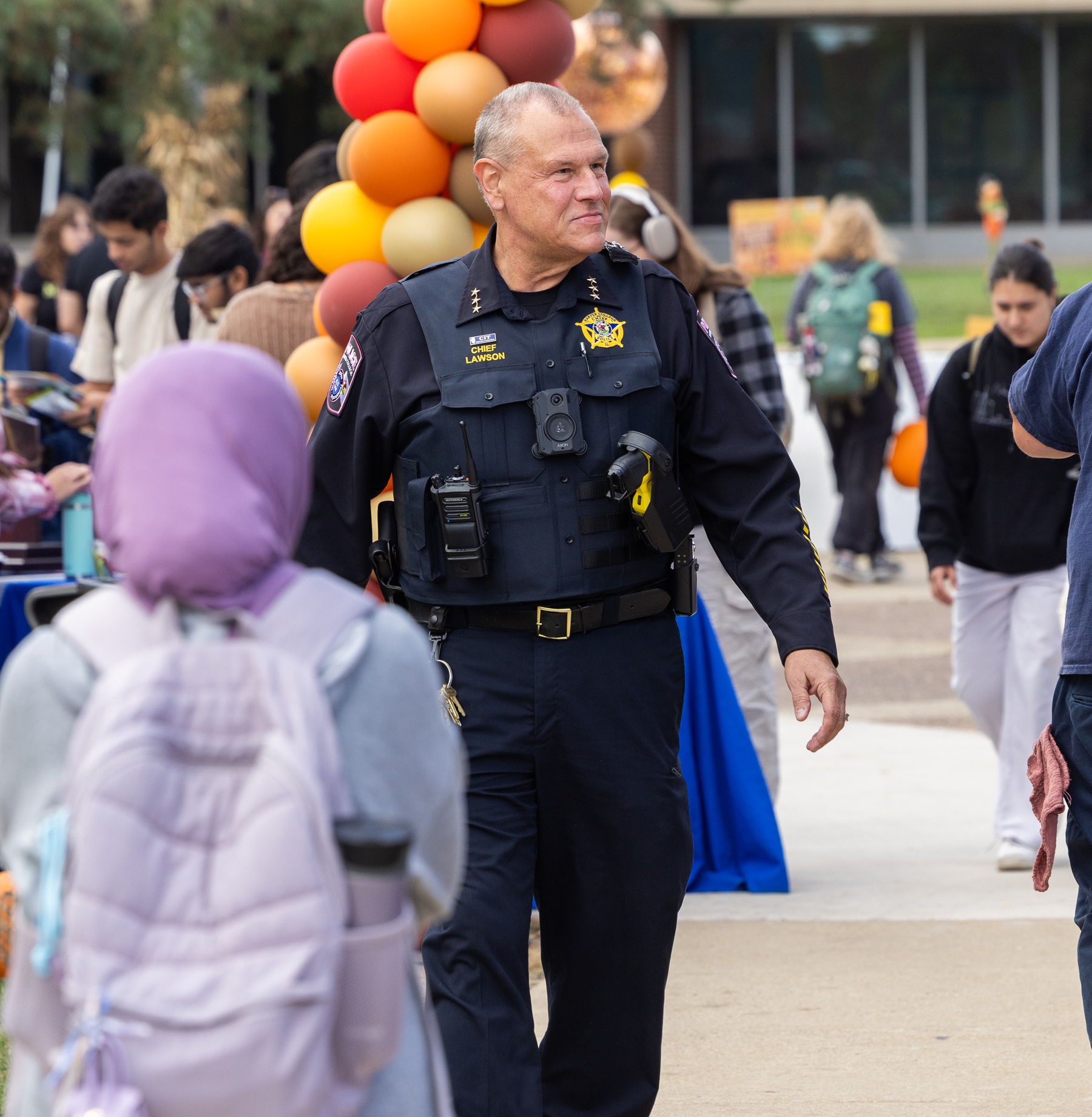 Harper Police Chief John Lawson walks through an event