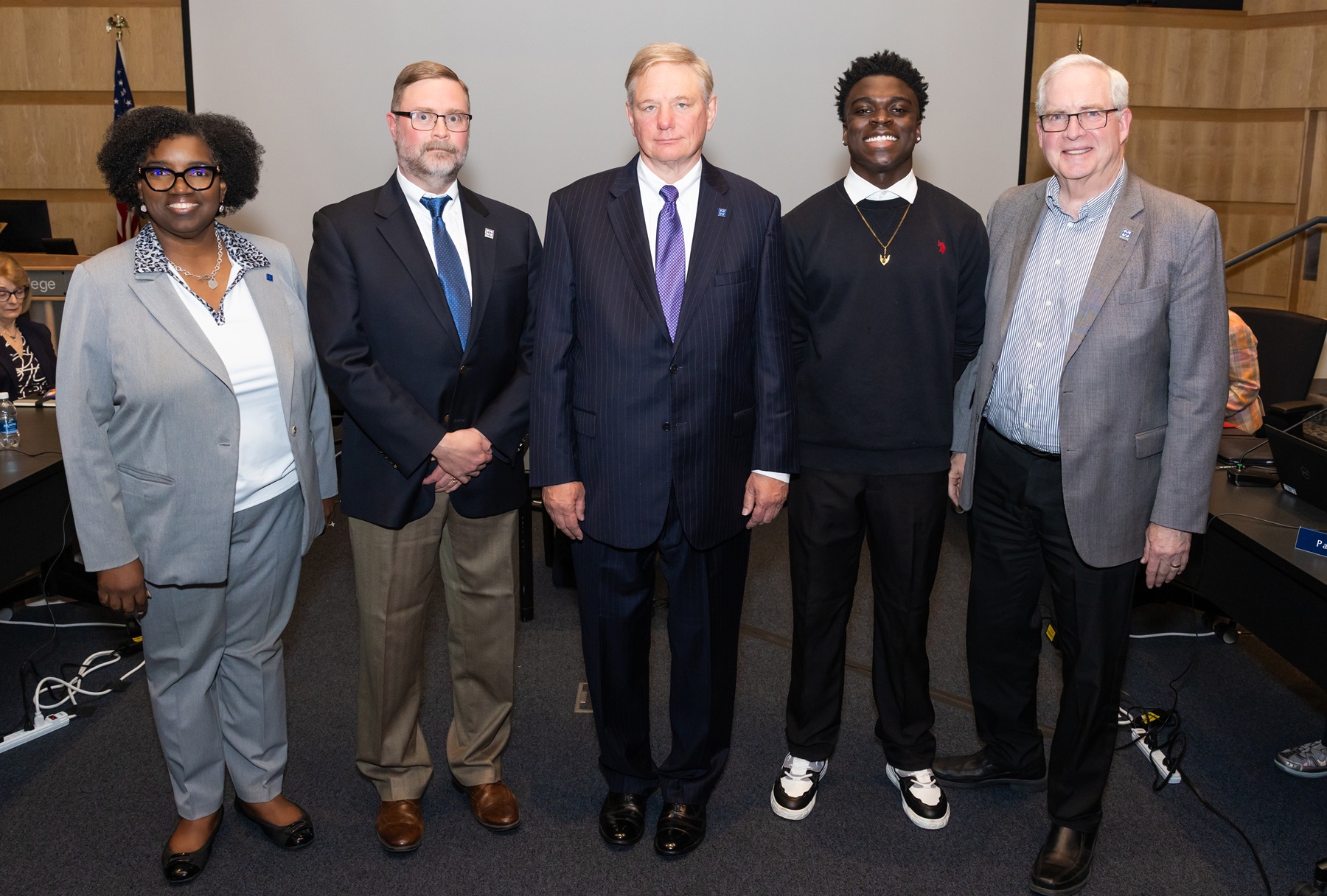 Dr. Avis Proctor, Eric Knox, James Meyer, Adekunbi Aransiola and Bill Kelley stand at the April Harper College Board of Trustees meeting.