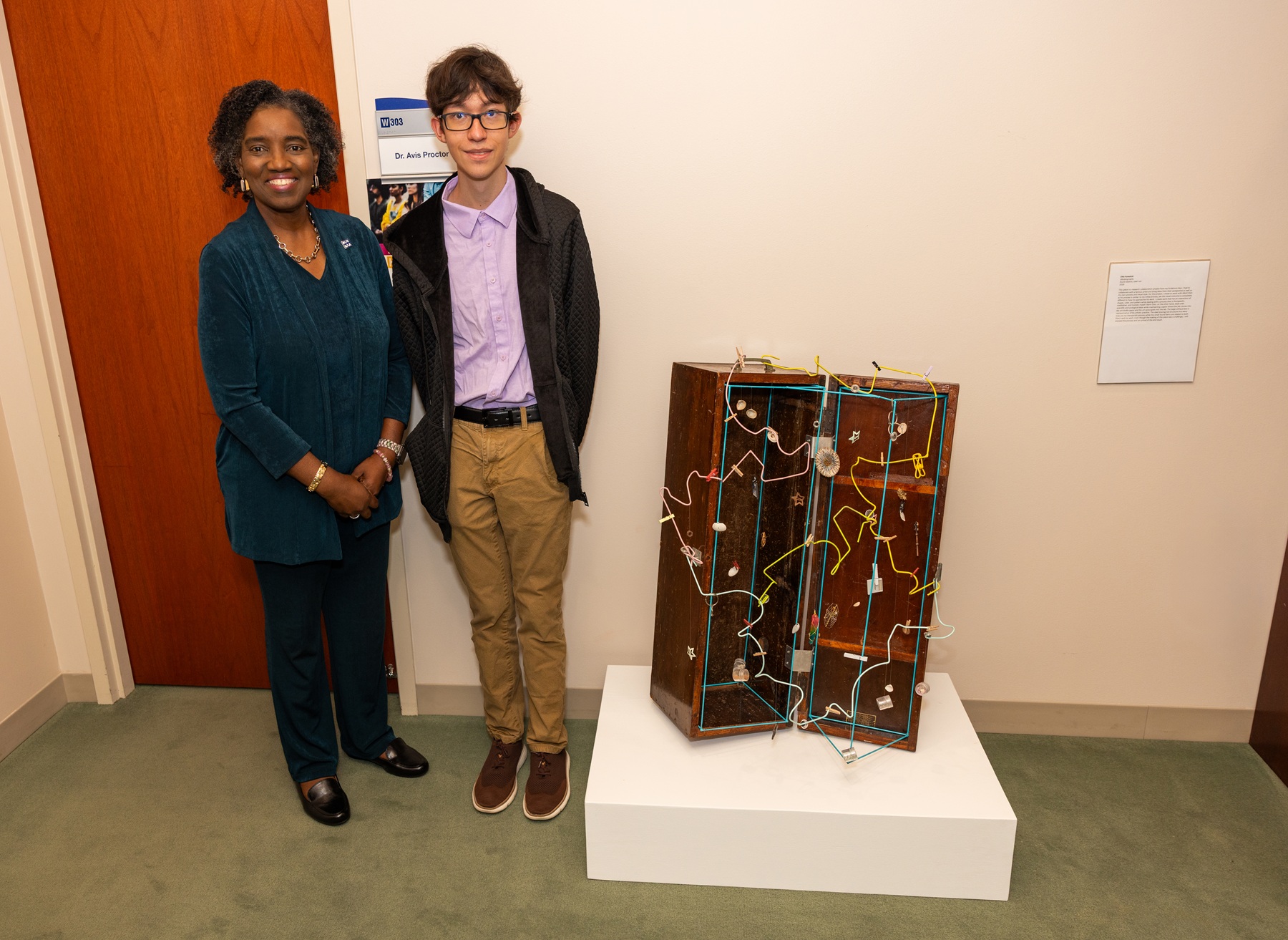 Harper College alumnus Otto Kowalski stands with his artwork next to Dr. Avis Proctor