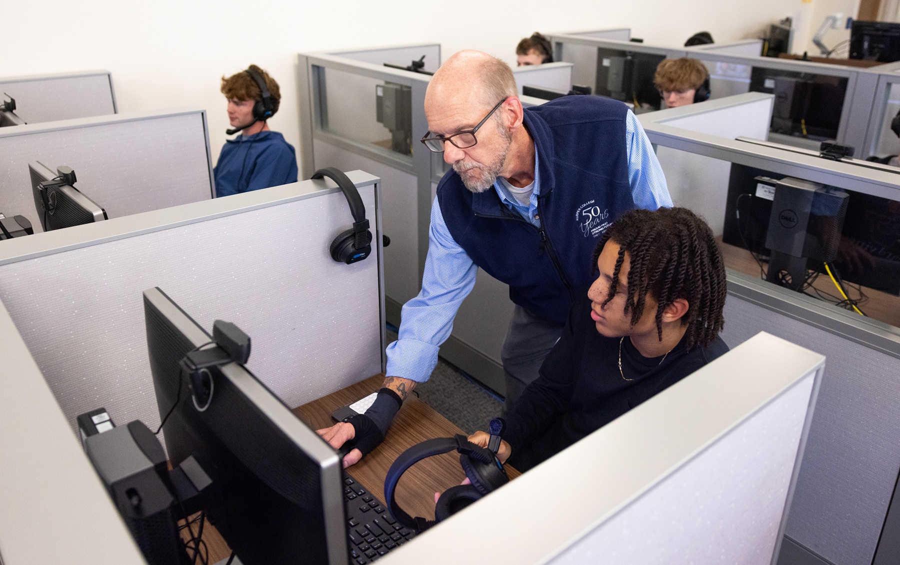 Richard Johnson helps a student in the classroom