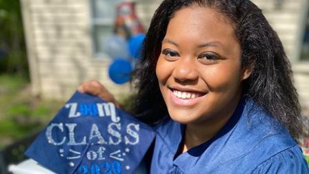 Harper College graduate Rochelle Washington holds her decorated cap