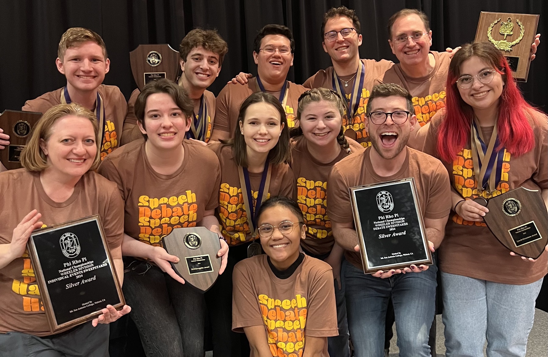 Harper's 2024 Speech and Debate Team poses after winning nationals