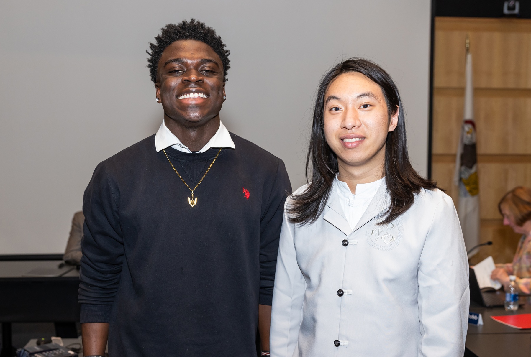 New Student Trustee Adekunbi Aransiola and former Student Trustee Liman Lei stand at the April Harper College Board of Trustees meeting.