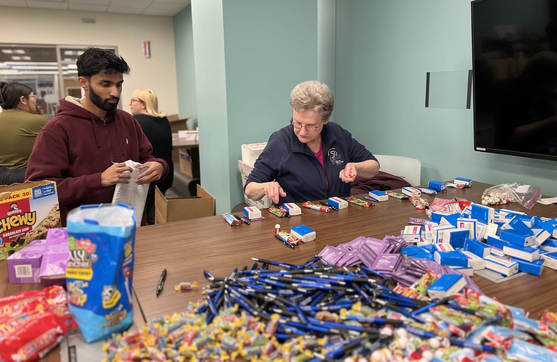 Atif Shareif and Stephanie Wootten pack thrive kits to support Harper students.