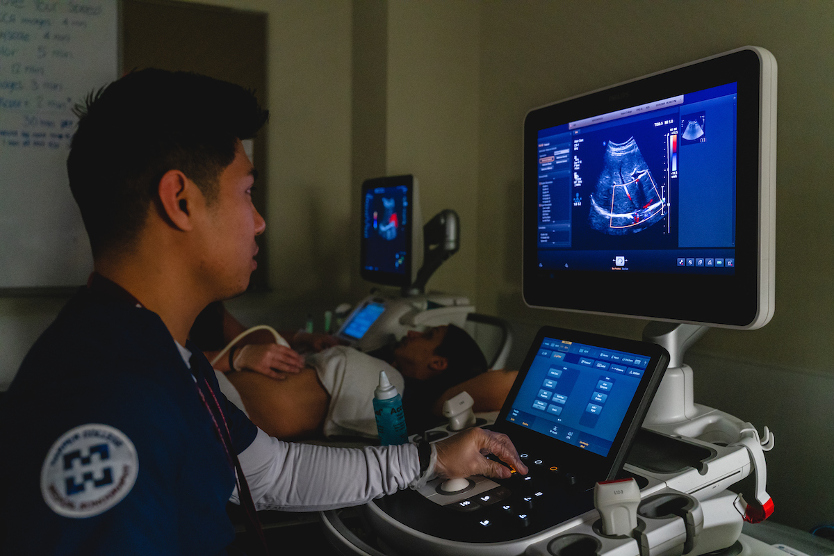 A Harper student performs an ultrasound