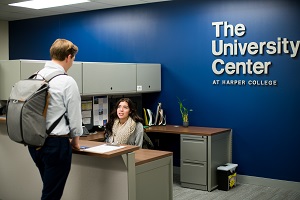 A University Center employee welcomes a student
