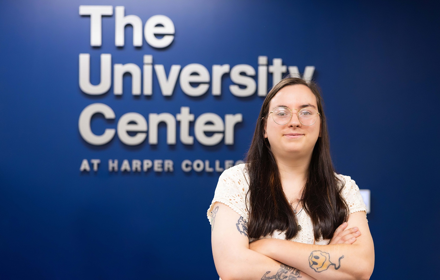 Student Angeline Gabby Aleksov stands in front of The University Center sign
