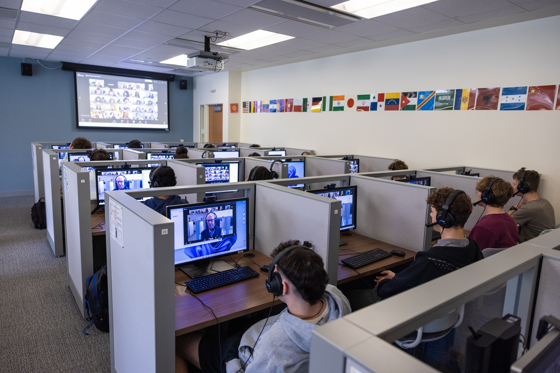 Harper students sit at computers to communicate with students in Mexico for a Virtual Exchange program
