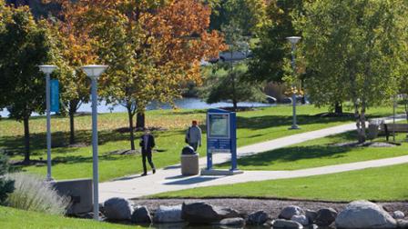 View of students on campus, leaves just starting to change for fall.