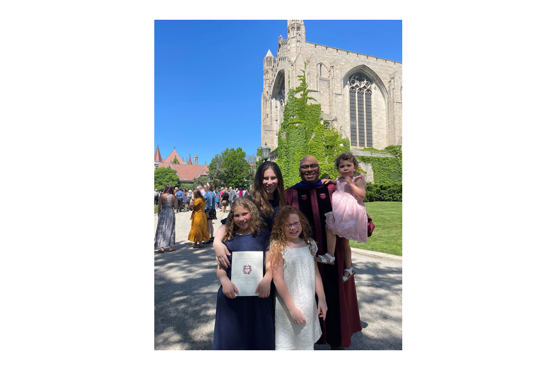 Harty with his wife and three children at PhD ceremony