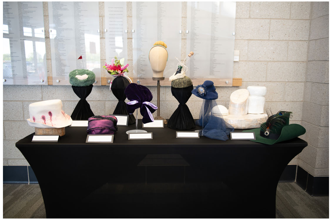Student hats displayed on a table.