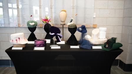 A table displaying hats handmade by students.