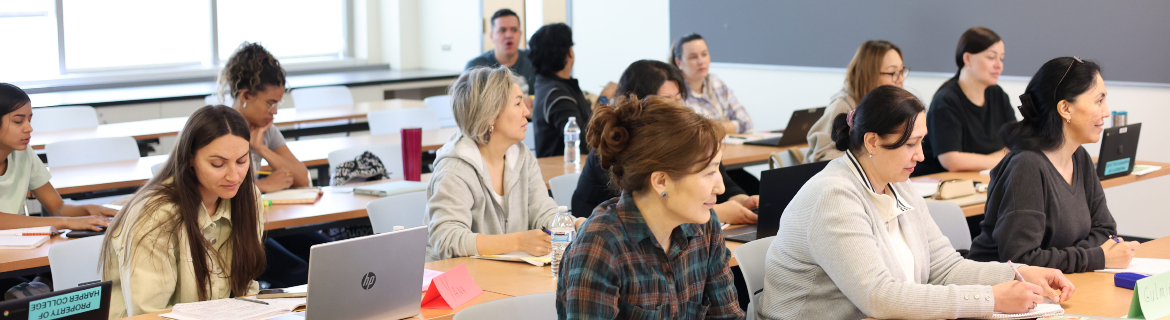 Students in Harper College's English Literacy Acquisition program listen and take notes on laptops during a lecture in classroom on campus in Palatine, Illinois.