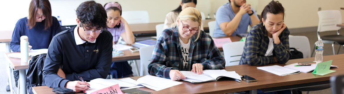 Students in Harper College's High School Equivalency program work on analyzing a book in their English class on campus in Palatine, Illinois.