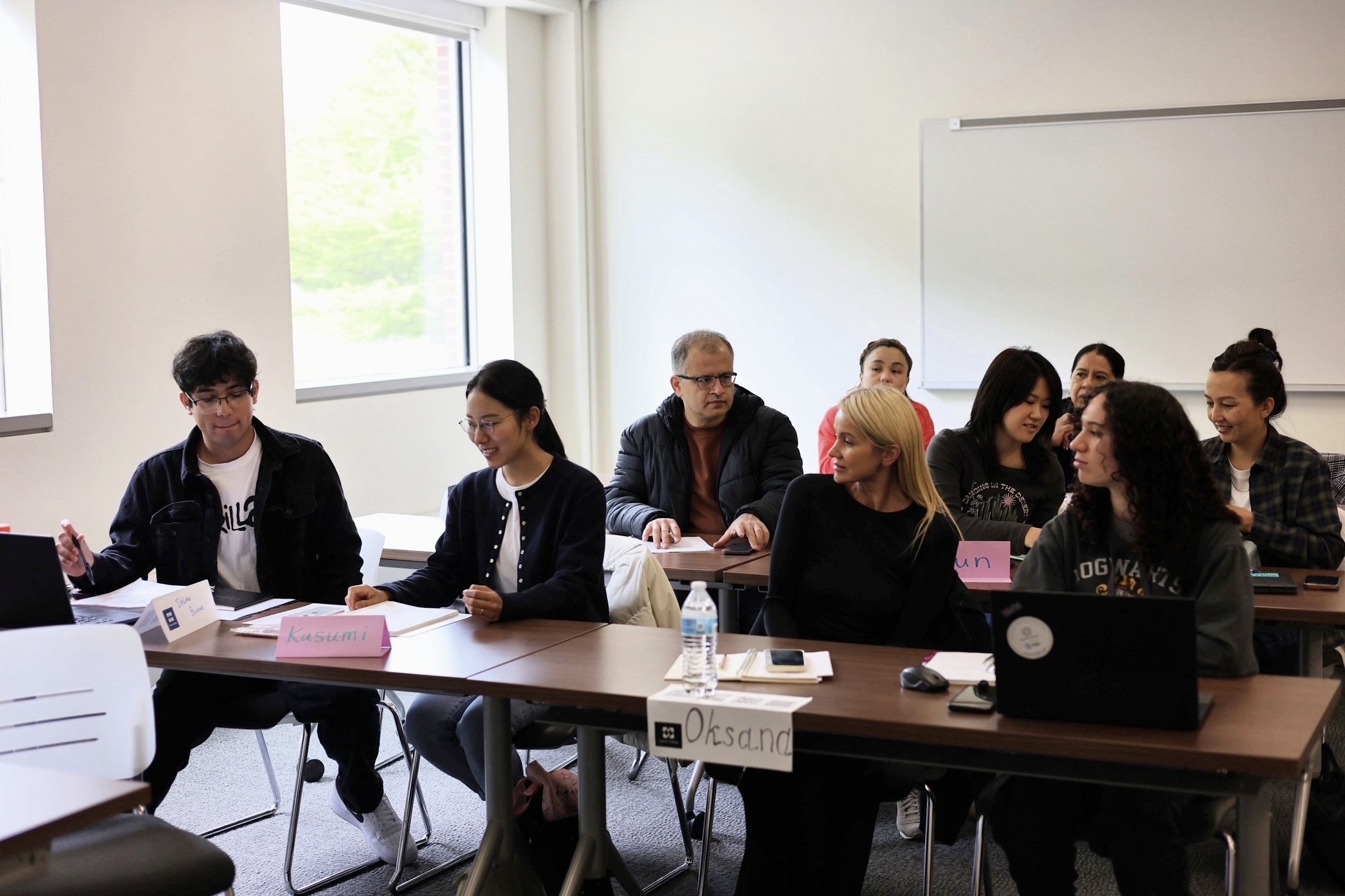 Students in AED's High School Equivalency (HSE) program discuss and assignment in a classroom on the Harper College campus in Palatine, Illinois.