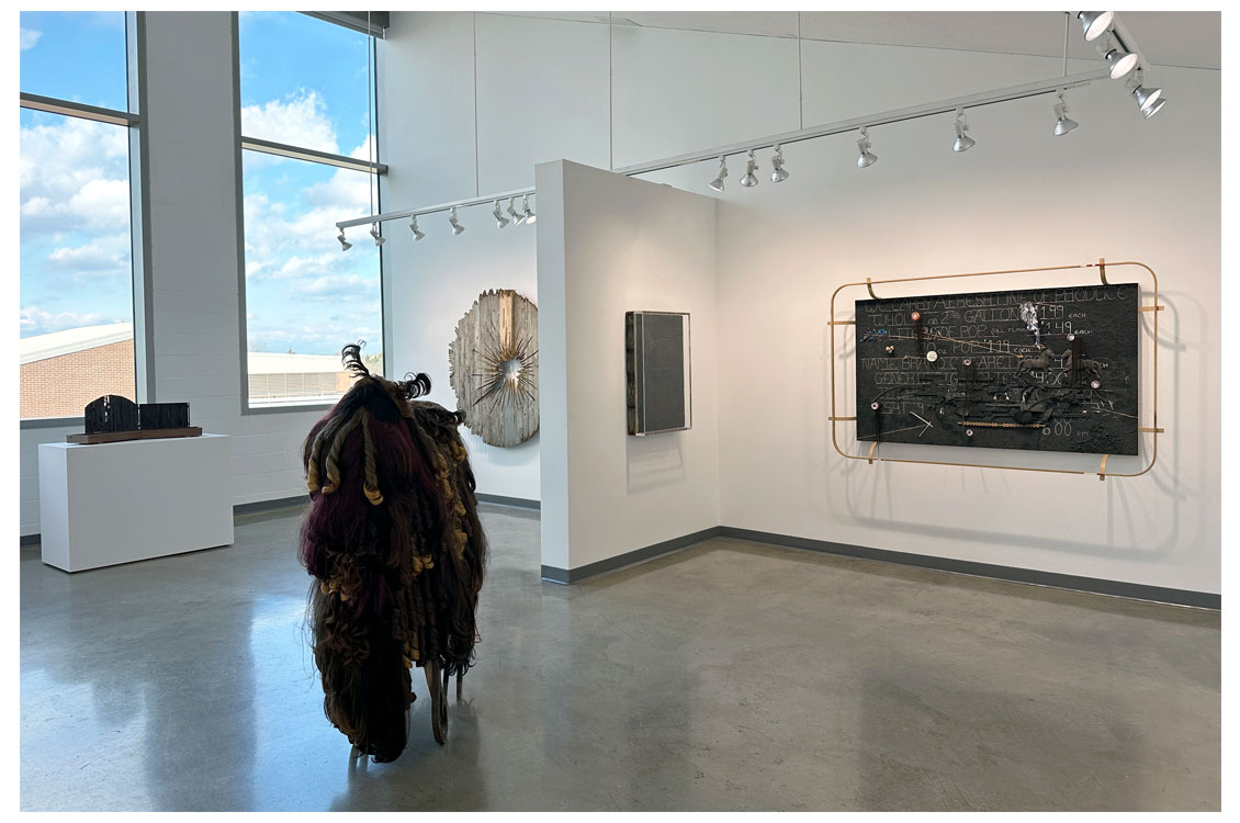 interior gallery view with a sculpture at the focal point