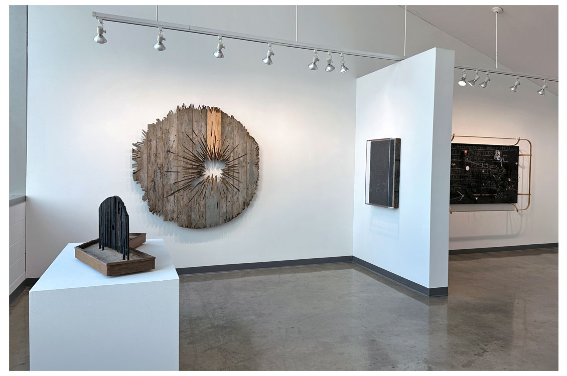 interior gallery view with round art piece hung on wall