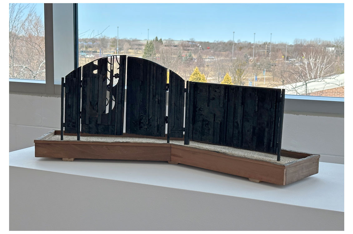 an abstract sculpture made out of burnt wood
