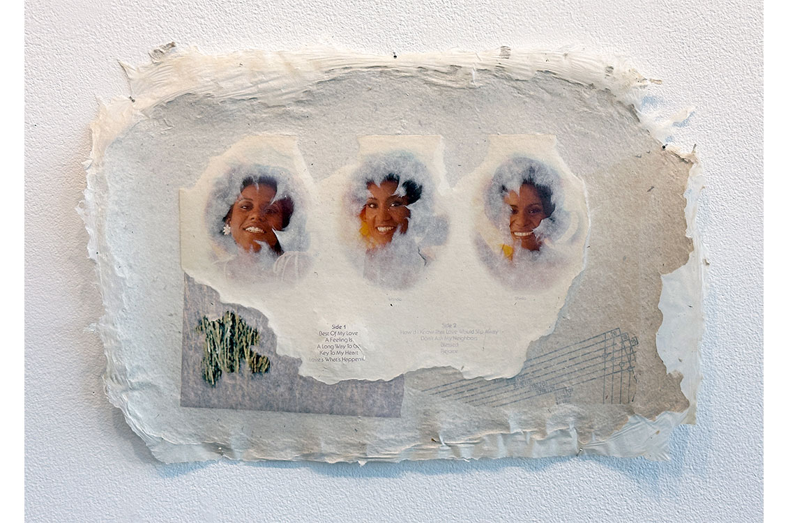 A crinkled piece of rough white paper is the background for a collage of paper, textures, and images, featuring three individual photos of women in the middle