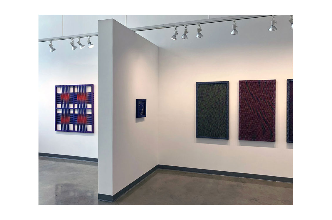photo of installation, four different paintings on walls