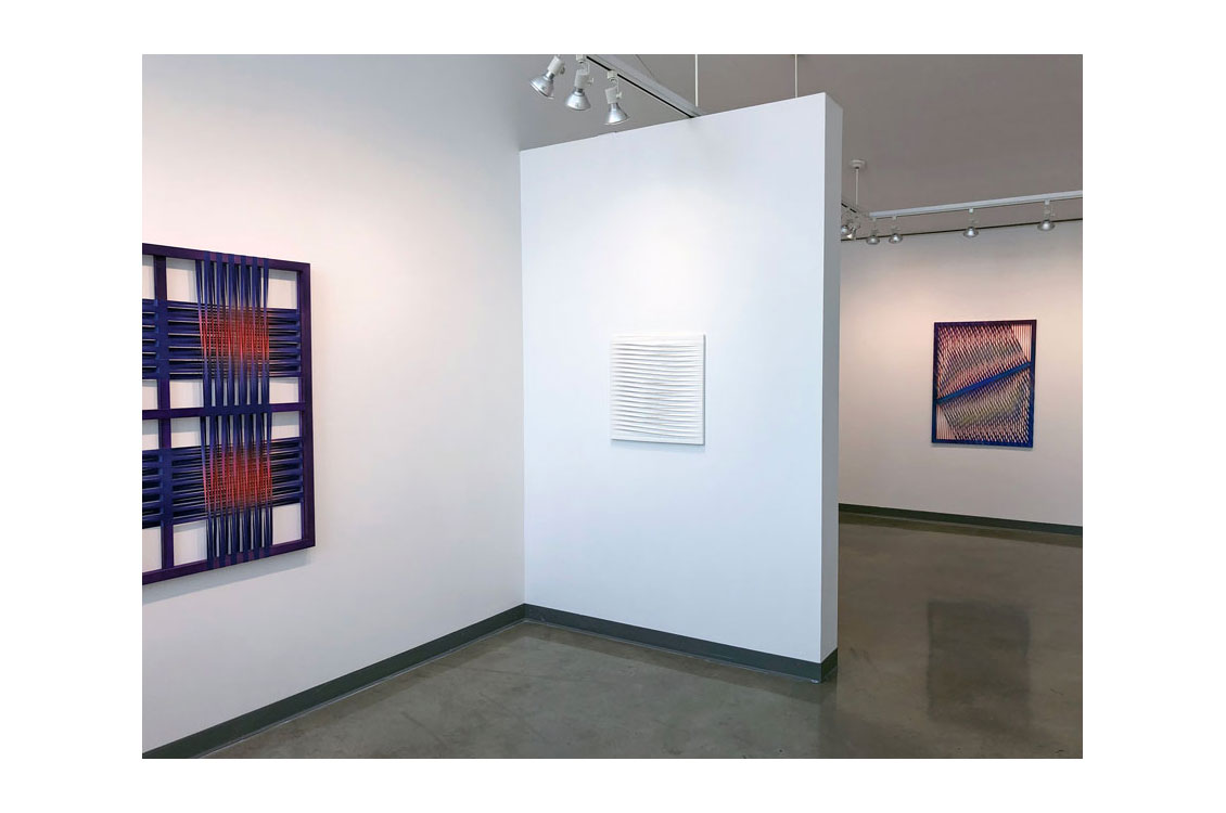 photo of installation with three different works on the walls
