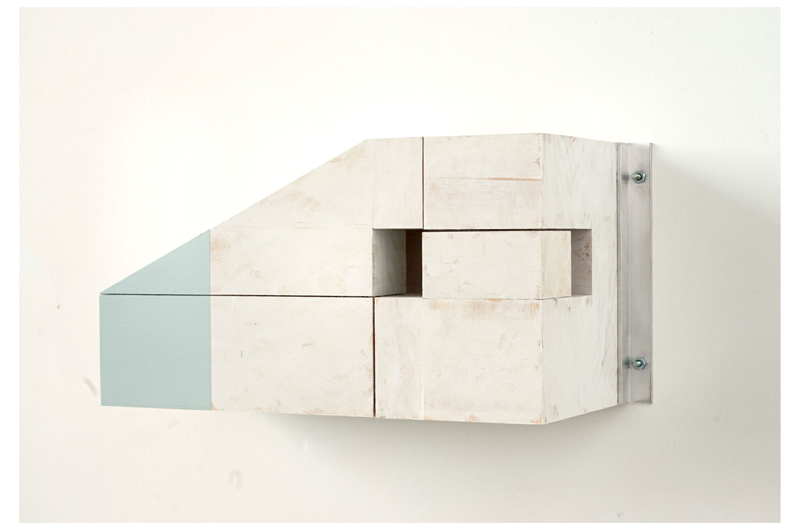 Angular white wood sculpture with blue painted section.