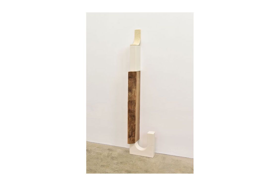 wood and porcelain sculpture, long with a curved handle at the end