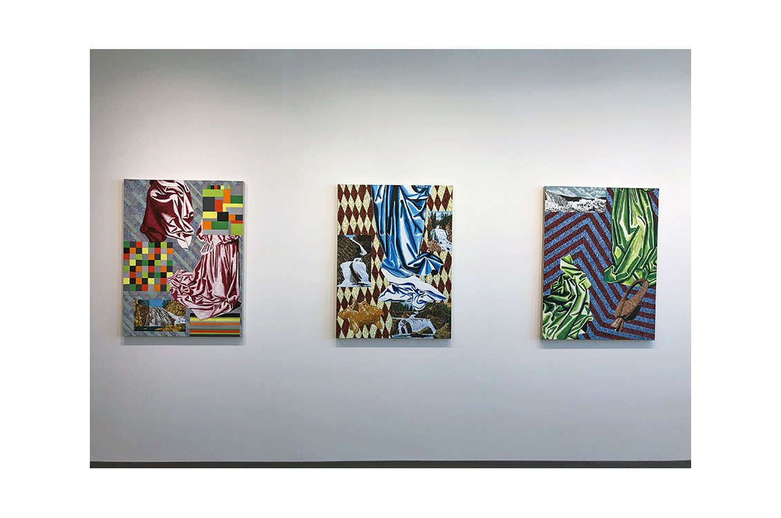 three paintings on wall in gallery