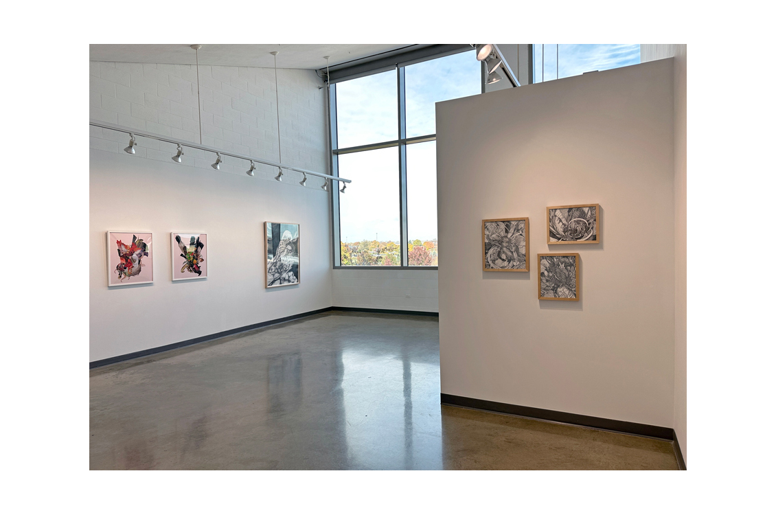 gallery interior with window in background and paintings on walls