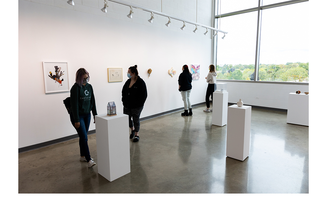 Students view works in the exhibition space