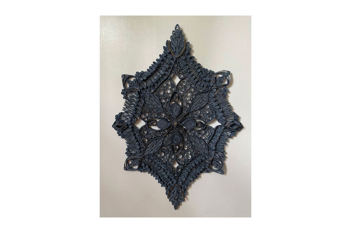 filigree wall hanging made of deconstructed blue jeans