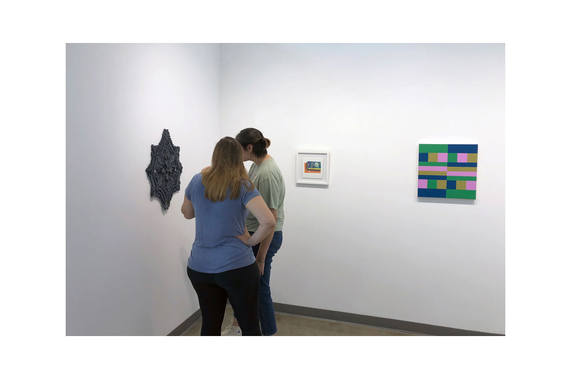 two students view Mother in the gallery