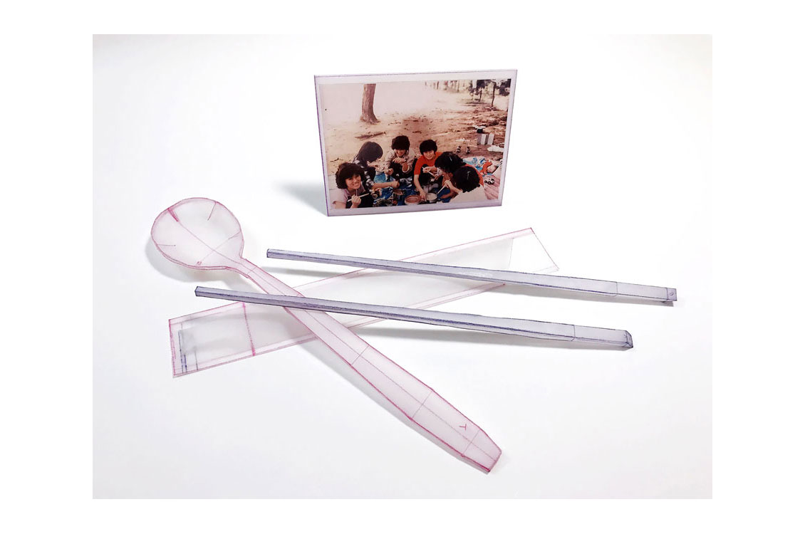 color pencil drawing of plastic cutlery displayed along with a family photograph