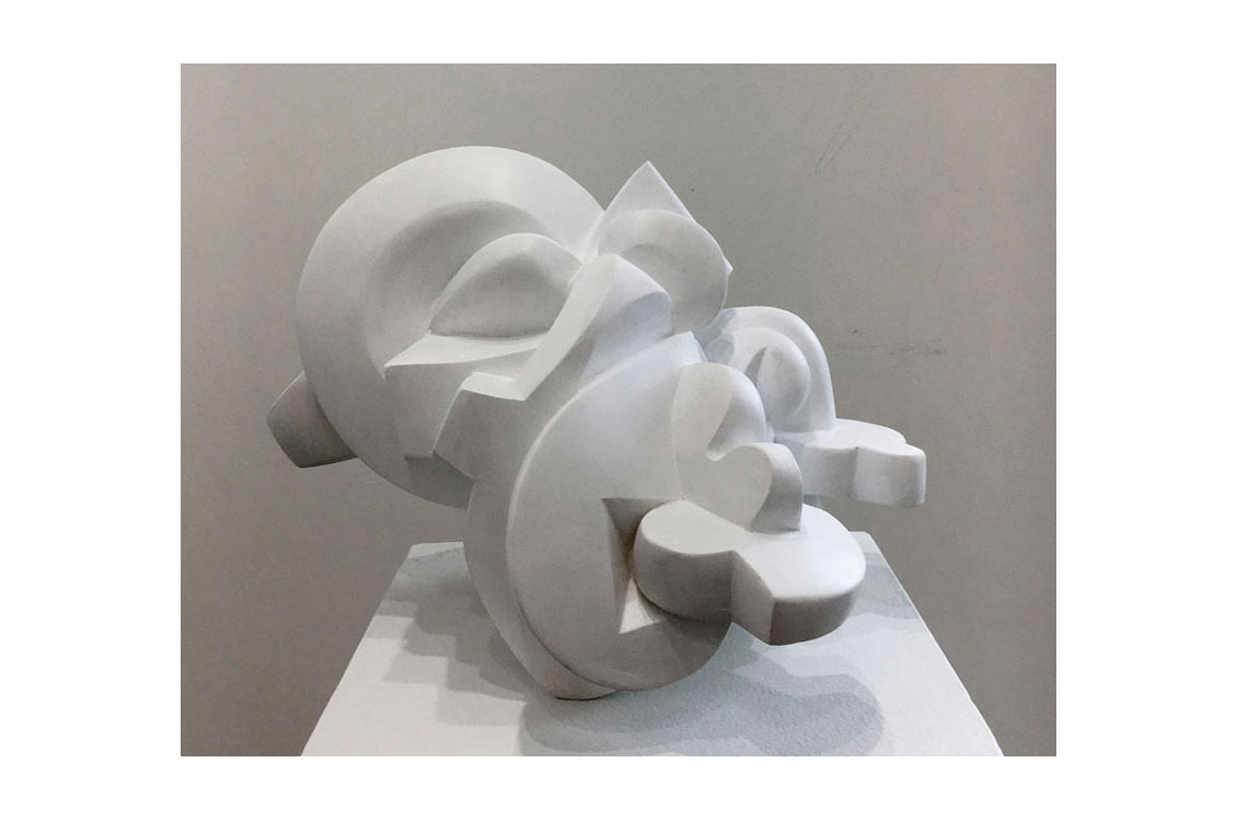 abstract sculpture of a white shape that casts interesting shadows