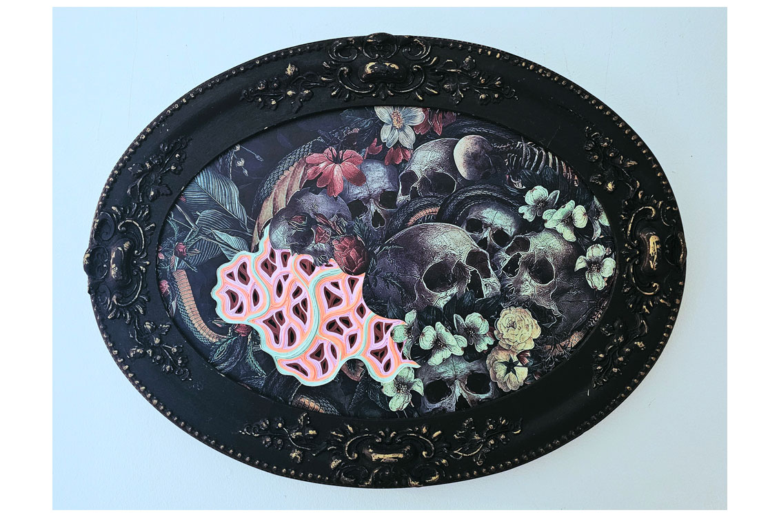 Ornate black oval frame with dark artwork of skulls, flowers, butterflies, and a pink geometric overlay.