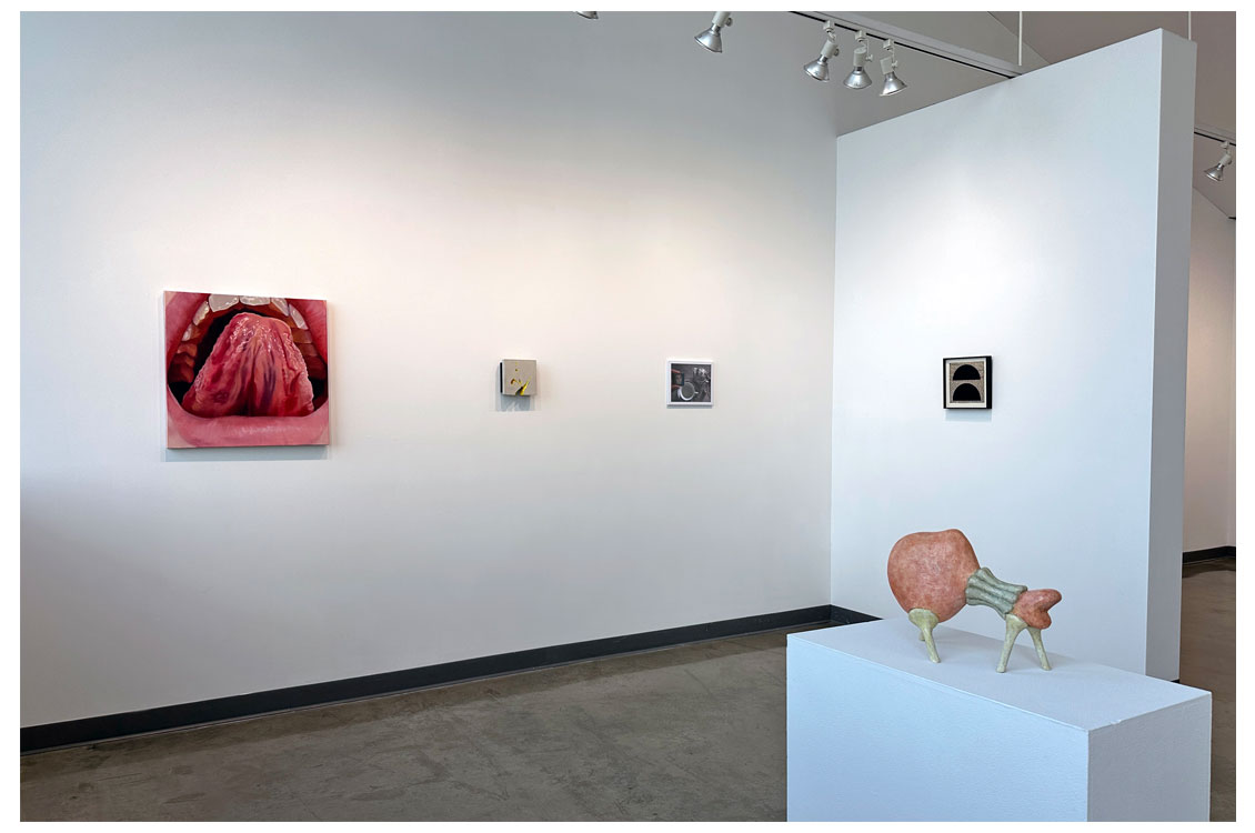 painting of mouth on wall with three other small paintings
