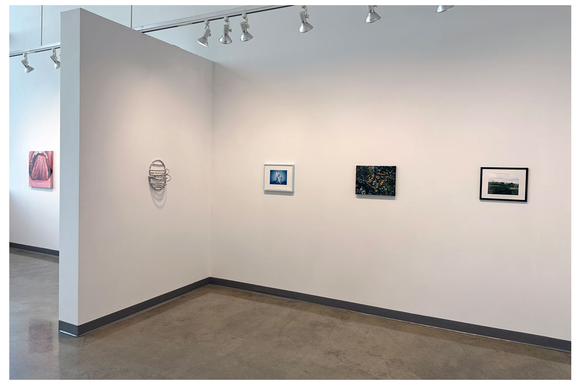 four paintings on wall wrapping around corner