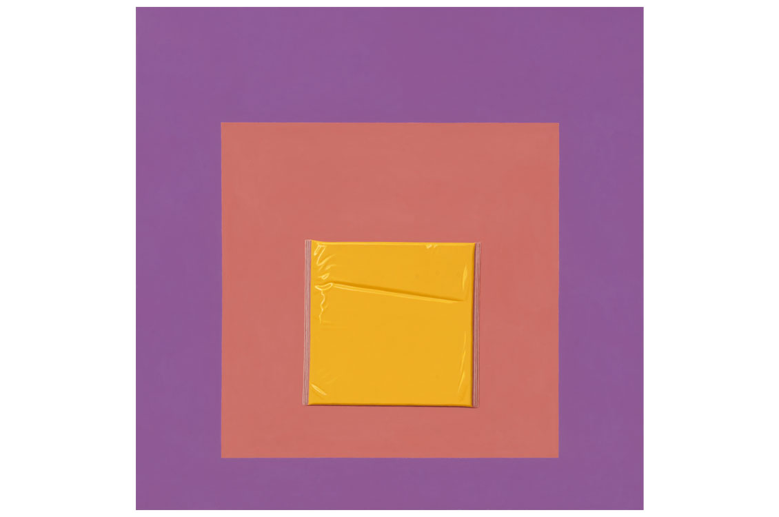 Photograph of a wrapped slice of yellow cheese centered on nested orange and purple squares.