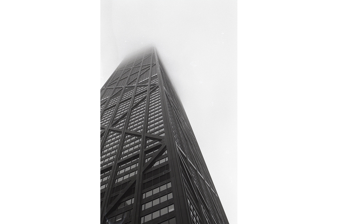 photograph looking up at a skyscraper from the base of the building