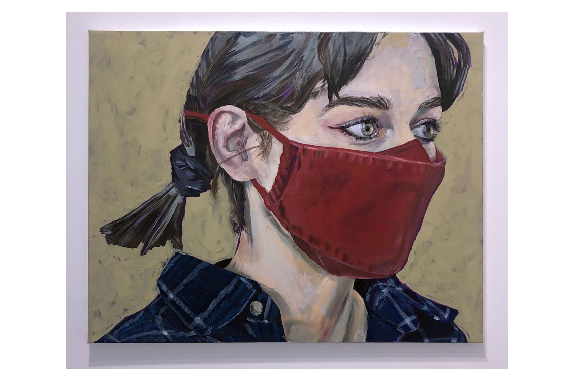 portrait of woman wearing a red face mask