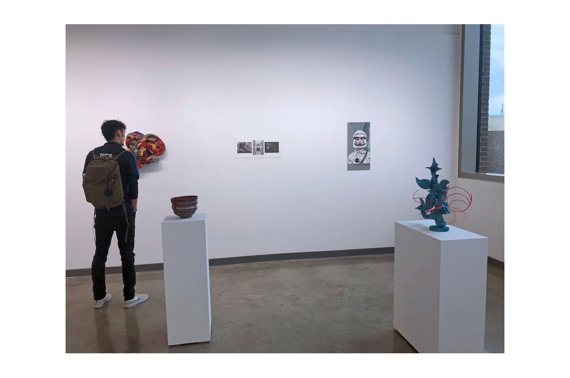 student viewing a painting in the gallery