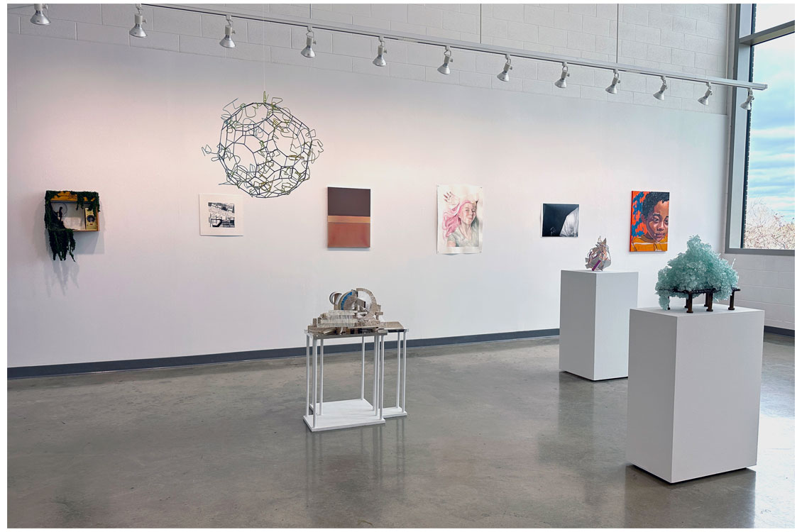 interior gallery view with sculptures at center