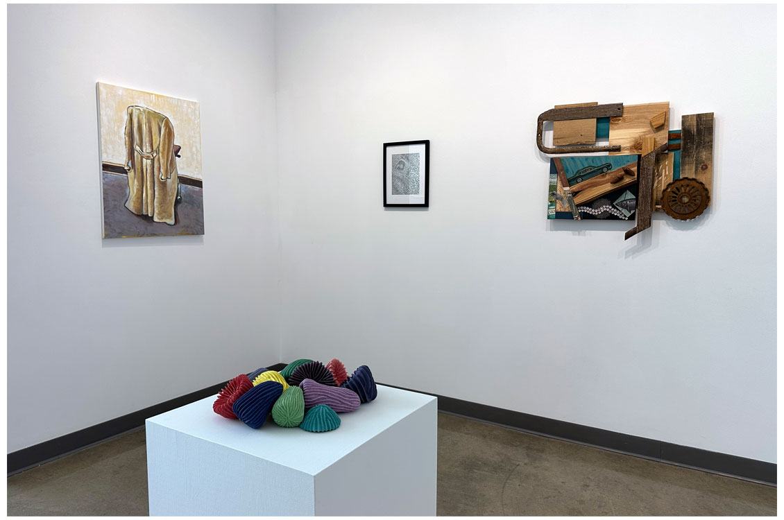 view of a gallery with paintings on the wall and a sculpture in the foreground