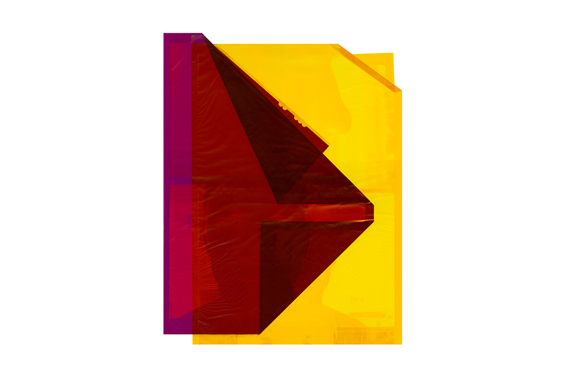 Transparent red and yellow shapes overlap the shadow of a portrait photograph.