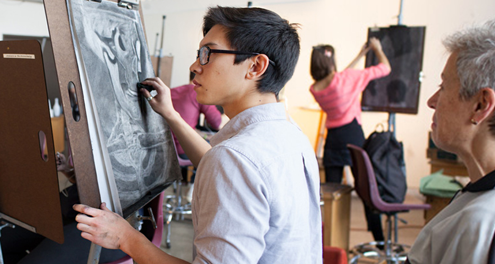 Student painting on canvas