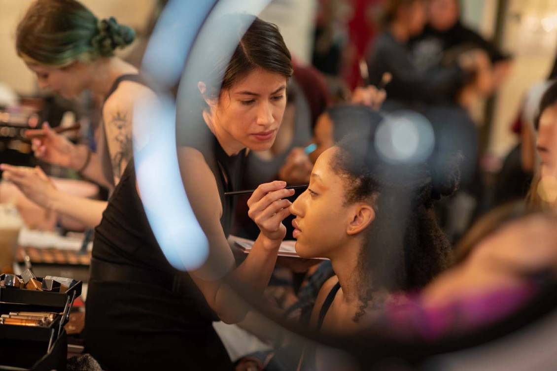 Model getting make-up put on them before the show