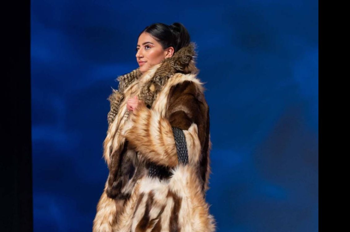 Model wearing a long fur coat